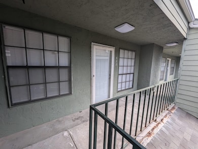 Entrance to property featuring stucco siding