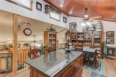 Kitchen with a ceiling fan, vaulted ceiling, wood 