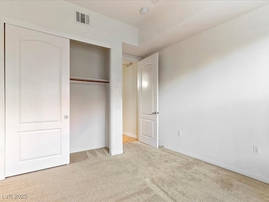 Unfurnished bedroom with light colored carpet, a c