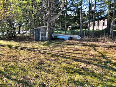 Level lot on Round Lake 1.85 acres with wooded pri