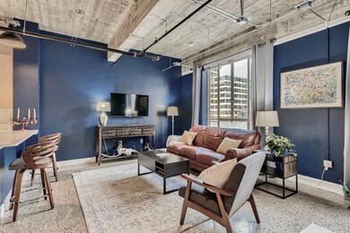 Living room featuring speckled floor and baseboar