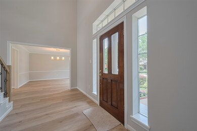 Natural light floods the foyer through wall of win