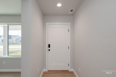 Entryway featuring wood finished floors and recessed lighting