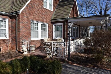 View of Tile Roof. Side Patio. Wrought iron railin