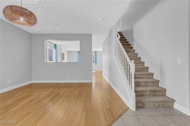 Staircase featuring wood finished floors and baseb