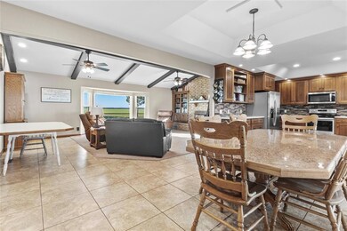 Dining area with lofted ceiling with beams, light 
