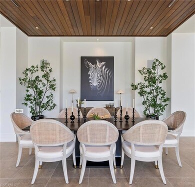 Dining area with wooden ceiling and tile patterned flooring