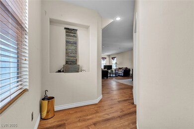 Hallway featuring wood finished floors and recesse