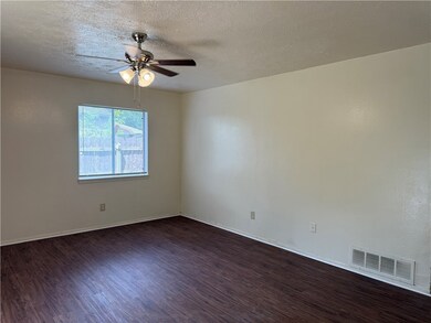 Spare room with ceiling fan, dark wood-style floor