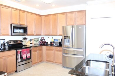 Kitchen with crown molding, light tile patterned f