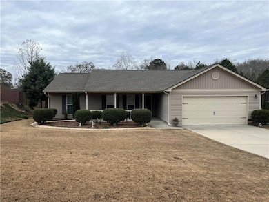 Single story home featuring a porch, driveway, roo