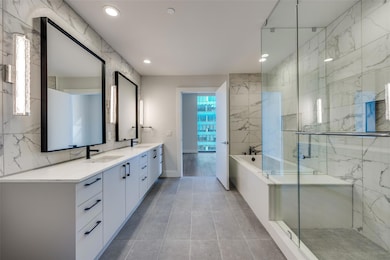 Bathroom with tile patterned floors, vanity, and s