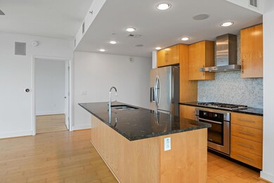 Kitchen with wall chimney exhaust hood, appliance