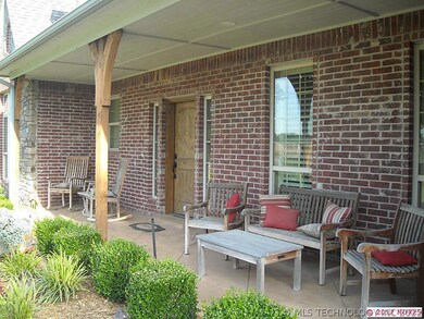 A large covered front porch with wood supports and