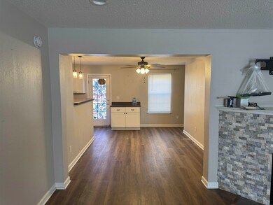 Unfurnished living room with ceiling fan with nota