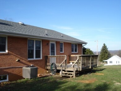 back of house with deck