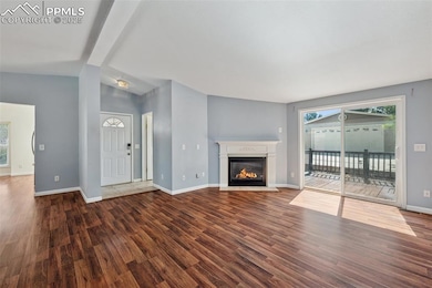 Large living space with gas fireplace and walks out to deck