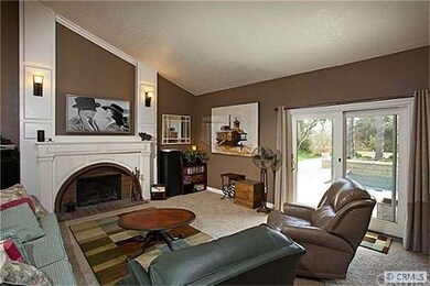 Family room with fireplace and views of the pool