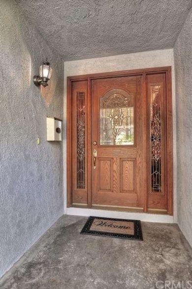 As you walk up to the front door, you are welcomed by a serene walkway surrounded by lush landscaping and a shady seating area. The wonderful grassy area and brick trim on the home gives you wonderful curb appeal.