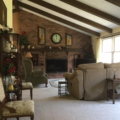 Bright living room with cathedral ceiling, large w