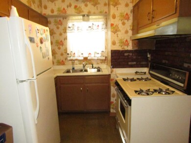 Kitchen with sink, decorative backsplash, and whit