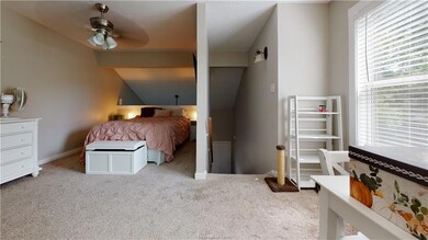 Carpeted bedroom featuring vaulted ceiling and bas