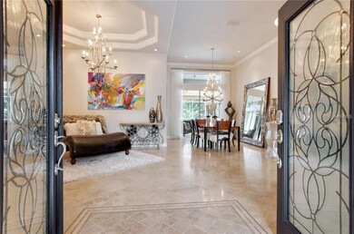 Beautiful glass front doors open to the foyer, liv