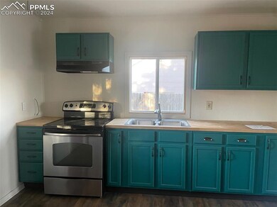 Kitchen with dark hardwood / wood-style flooring, 