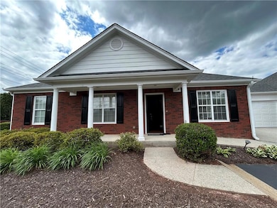 View of front of house featuring a porch and brick