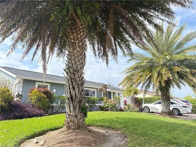 View of front of home with a front lawn and stucco