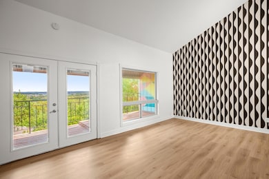 Vaulted ceilings and natural light make this living space feel open, modern, and effortlessly inviting