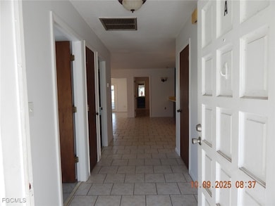 Corridor with light tile patterned floors