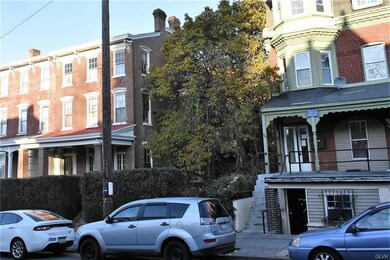 Double lot includes unit with red porch roof and l