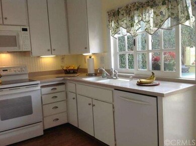 Adorable kitchen with corian countertops 