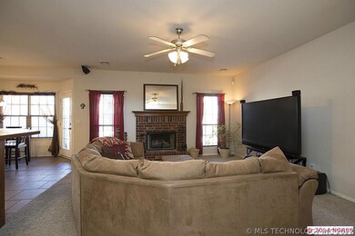 Inviting Family Room displays warm brick fireplace