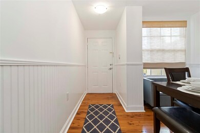 Entry with wainscoting and wood floors