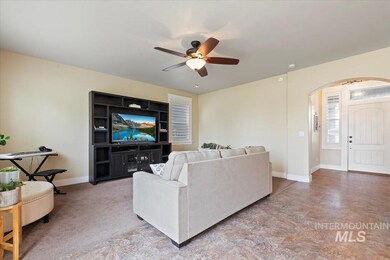 Living area featuring ceiling fan and arched walkways