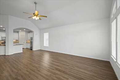 Unfurnished living room featuring lofted ceiling,