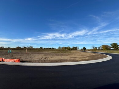 View of asphalt road with curbs and a view of countryside