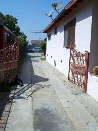 Gated Driveway leading to back house and carport