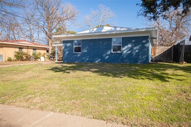 View of side of property featuring a yard