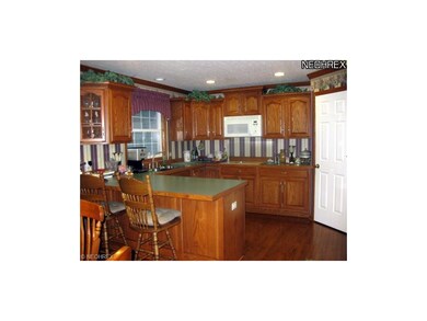 The eat-in kitchen offers plenty of counter and st