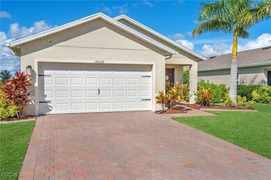Single story home with decorative driveway, stucco siding, an attached garage, and a front yard