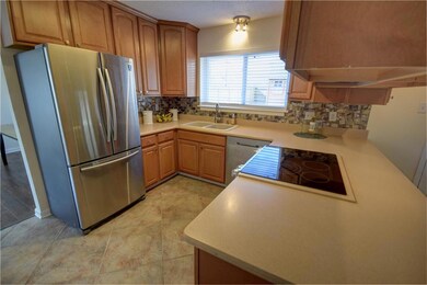 Kitchen with corian counter and SS appliances