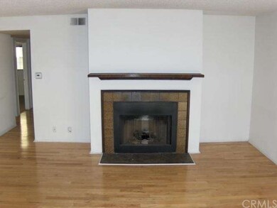Living room with fireplace and maple hardwood floo