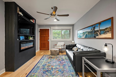 Living room featuring light wood-style floors, ba