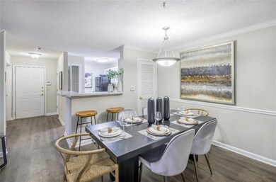 Dining area with a textured ceiling and dark hardw
