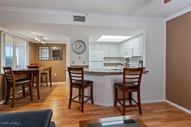 Kitchen featuring white appliances, a peninsula, l