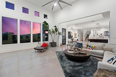 Living area with finished concrete floors, a ceil