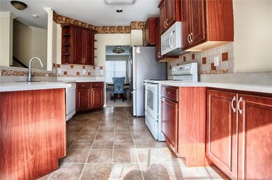 Cherry cabinets, stone backsplash, stainless steel